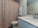 Well-lit bathroom featuring a patterned shower curtain, vanity with sink, and convenient towel rack at 533 Cedar Knoll Cir, Pineville, NC 28134