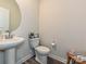Charming half bathroom featuring modern fixtures, pedestal sink, and stylish decor for added convenience at 533 Cedar Knoll Cir, Pineville, NC 28134