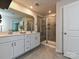 Bright bathroom showcasing dual sinks, quartz counters, tiled floors and glass enclosed walk in shower at 533 Cedar Knoll Cir, Pineville, NC 28134