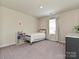 Cozy bedroom with light walls, window, carpet and simple decor for a comfortable living space at 533 Cedar Knoll Cir, Pineville, NC 28134