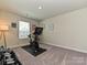 Well-equipped exercise room with stationary bike, weights, carpet, and natural light for fitness enthusiasts at 533 Cedar Knoll Cir, Pineville, NC 28134