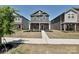 Charming two-story home featuring a stone facade, covered porch, and manicured front yard, creating an inviting curb appeal at 533 Cedar Knoll Cir, Pineville, NC 28134