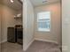 Functional laundry room equipped with a modern washer and dryer, a storage shelf and natural light at 533 Cedar Knoll Cir, Pineville, NC 28134
