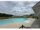Resort-style community pool with a sundeck and inviting clear water, complemented by views of surrounding homes at 533 Cedar Knoll Cir, Pineville, NC 28134