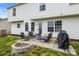 Outdoor patio seating area with a fire pit and grill, perfect for entertaining at 5549 Lemley Nw Rd, Concord, NC 28027