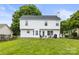 Well-maintained backyard with lush lawn, outdoor seating area, and classic white two-story home at 5549 Lemley Nw Rd, Concord, NC 28027