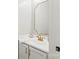 Bright bathroom featuring a white vanity with gold fixtures and a decorative mirror at 5549 Lemley Nw Rd, Concord, NC 28027