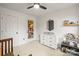 Bright bedroom with neutral color scheme, ceiling fan, dresser and geometric mirror at 5549 Lemley Nw Rd, Concord, NC 28027