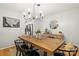 Bright dining room with rustic table, modern chandelier, and access to the kitchen at 5549 Lemley Nw Rd, Concord, NC 28027