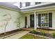 Charming home exterior with a welcoming entrance, decorative wreath, and a cozy front bench at 5549 Lemley Nw Rd, Concord, NC 28027