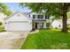 Charming two-story home with a well-manicured lawn and a two-car garage at 5549 Lemley Nw Rd, Concord, NC 28027