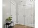 Hallway with neutral walls and tiled floor with two closets and modern decor at 5549 Lemley Nw Rd, Concord, NC 28027