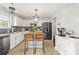 Modern kitchen with white cabinets, dark countertops, and stainless steel appliances at 5549 Lemley Nw Rd, Concord, NC 28027