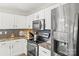 Bright kitchen with white cabinetry, stainless steel appliances, and modern backsplash at 5549 Lemley Nw Rd, Concord, NC 28027