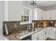 Well-lit kitchen with stainless steel appliances, granite countertops, and mosaic tile backsplash at 5549 Lemley Nw Rd, Concord, NC 28027