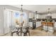 Sun-lit kitchen with white cabinetry, island seating, and stainless steel appliances at 5549 Lemley Nw Rd, Concord, NC 28027