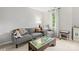 Neutral living space showcasing a comfortable gray sofa and side chair near a window with decorative toys and furniture at 5549 Lemley Nw Rd, Concord, NC 28027