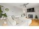 Cozy living room with a plush sectional sofa, fireplace, and neutral decor at 5549 Lemley Nw Rd, Concord, NC 28027