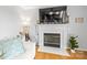 Living room highlighting a fireplace with white mantle, hardwood floors, and modern decor at 5549 Lemley Nw Rd, Concord, NC 28027