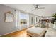 Bright living room with hardwood floors, neutral sofa, and large windows overlooking the lawn at 5549 Lemley Nw Rd, Concord, NC 28027