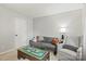 Neutral living space showcasing a comfortable gray sofa and side chair near a door and window with decorative toys at 5549 Lemley Nw Rd, Concord, NC 28027