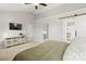 Bright main bedroom with a high ceiling, TV, and modern sliding barn door to the bathroom at 5549 Lemley Nw Rd, Concord, NC 28027