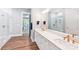 Stylish bathroom featuring double vanity sinks, wood flooring, and a glass enclosed shower at 6006 Waxhaw Crossing Dr, Waxhaw, NC 28173