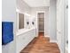 Modern bathroom featuring double vanity sinks, wood flooring, and a walk-in closet at 6006 Waxhaw Crossing Dr, Waxhaw, NC 28173
