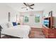 Comfortable bedroom with natural light, wood-look floors, a ceiling fan, and a full size bed at 6006 Waxhaw Crossing Dr, Waxhaw, NC 28173