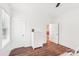 Bright bedroom with wood-look floors, white trim, and natural light from the window at 6006 Waxhaw Crossing Dr, Waxhaw, NC 28173