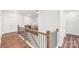 Hallway with wood-trimmed railing, iron balusters, and modern flooring leading to other rooms at 6006 Waxhaw Crossing Dr, Waxhaw, NC 28173