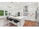 Modern kitchen featuring an island with bar seating, stainless steel appliances, and pendant lighting at 6006 Waxhaw Crossing Dr, Waxhaw, NC 28173