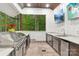 Entertain with this fully equipped outdoor kitchen featuring stainless appliances and countertop seating with a view at 6006 Waxhaw Crossing Dr, Waxhaw, NC 28173