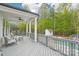 Relax on this covered porch overlooking the pool and backyard with plush seating and peaceful surroundings at 6006 Waxhaw Crossing Dr, Waxhaw, NC 28173