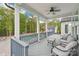 Relax on this covered porch overlooking the pool and backyard with plush seating and peaceful surroundings at 6006 Waxhaw Crossing Dr, Waxhaw, NC 28173