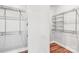 Spacious walk-in closet featuring wood flooring, white walls, and metal shelving units at 6006 Waxhaw Crossing Dr, Waxhaw, NC 28173