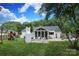 Spacious backyard with patio, outdoor fireplace, screened porch, play area, and lush landscaping at 6036 Sharon Acres Rd, Charlotte, NC 28210