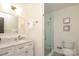 Well-lit bathroom features glass-enclosed shower, marble countertop vanity, and modern fixtures at 6036 Sharon Acres Rd, Charlotte, NC 28210