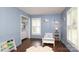 Airy bedroom with blue walls, plantation shutters, closet, and wood floors at 6036 Sharon Acres Rd, Charlotte, NC 28210