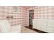 Pretty Bedroom featuring pink plaid wallpaper, a white dresser, and wood floors at 6036 Sharon Acres Rd, Charlotte, NC 28210