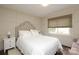 Serene bedroom with a tufted headboard, paneled walls, and a window with blinds at 6036 Sharon Acres Rd, Charlotte, NC 28210