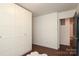 Neutral bedroom with built-in storage and hardwood floors at 6036 Sharon Acres Rd, Charlotte, NC 28210