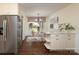 Cozy dining area featuring stainless steel refrigerator, stylish light fixture, and backyard views at 6036 Sharon Acres Rd, Charlotte, NC 28210