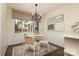 Bright dining area with backyard view, white wainscoting, and stylish modern decor at 6036 Sharon Acres Rd, Charlotte, NC 28210
