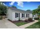 Charming home with manicured lawn, lush plantings, driveway, and classic exterior at 6036 Sharon Acres Rd, Charlotte, NC 28210