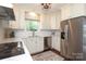 Bright kitchen features stainless steel appliances, white cabinets, and a window view at 6036 Sharon Acres Rd, Charlotte, NC 28210