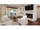 Comfortable living room featuring built-in shelving, a fireplace, and cozy seating arrangements at 6036 Sharon Acres Rd, Charlotte, NC 28210