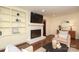 Living room with a fireplace, built-in shelving, and comfortable seating, great for entertaining at 6036 Sharon Acres Rd, Charlotte, NC 28210