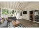 Bright and airy sunroom with comfortable seating, ceiling fan and sliding doors to the interior at 6036 Sharon Acres Rd, Charlotte, NC 28210