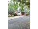 Exterior view of a charming brick home with a convenient carport and well-kept grounds at 6115 Amberly Ln, Charlotte, NC 28213